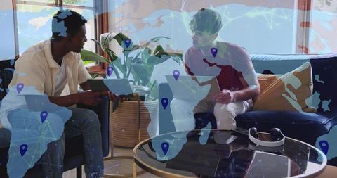 Two men collaborating with tablet and laptop, remote teamwork with virtual map overlay