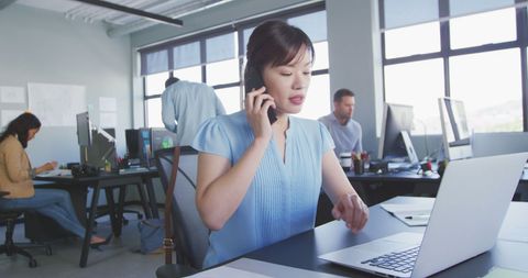 Businesswoman Calling Client in Modern Creative Office Environment