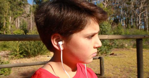 Focused Child Listening to Music Outdoors