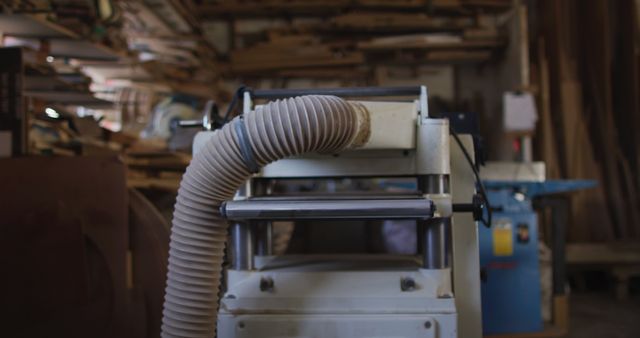 Machines and tools in a carpentry workshop suggest themes of craftsmanship and small business ownership. Useful for illustrating artisan features or promotional material related to custom furniture, handmade projects, and traditional woodworking.