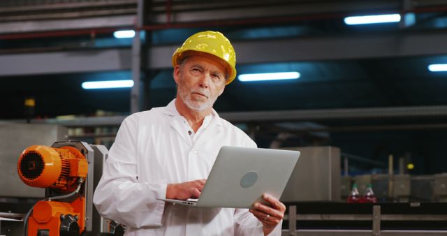 Senior Engineer Wearing Hard Hat Using Laptop in Factory - Download Free Stock Images Pikwizard.com