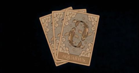 Mystical zodiac cards with aquarius design on dark surface