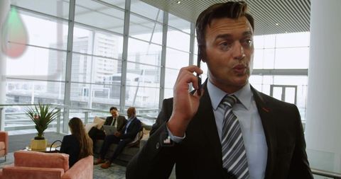 Professional Businessman Discussing on Smartphone in Modern Office Lounge