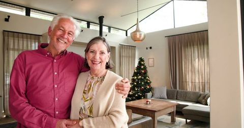 Senior couple embracing in elegant christmas living room