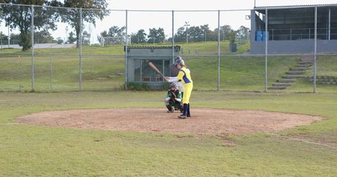 Female softball player preparing to swing at home plate