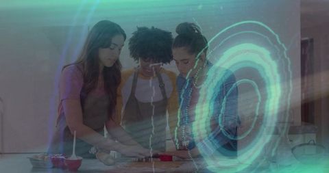 Three women baking together shaping cookie dough with rolling pin and teal light overlay