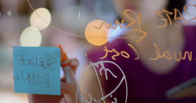 Person Writing on Glass Board with Sticky Notes and Marker - Download Free Stock Images Pikwizard.com