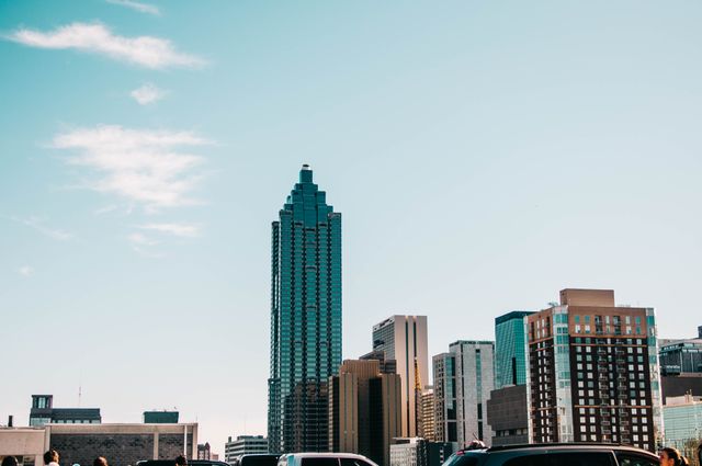 View of Atlanta skyline featuring modern skyscrapers against a clear blue sky. Ideal for use in business and travel brochures, urban planning presentations, or websites about Atlanta's architecture and development.