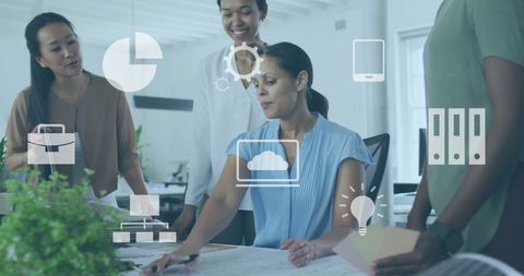Diverse business team analyzing data with icon overlay in modern office