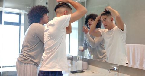 Father and Son Bonding While Styling Hair in Bathroom