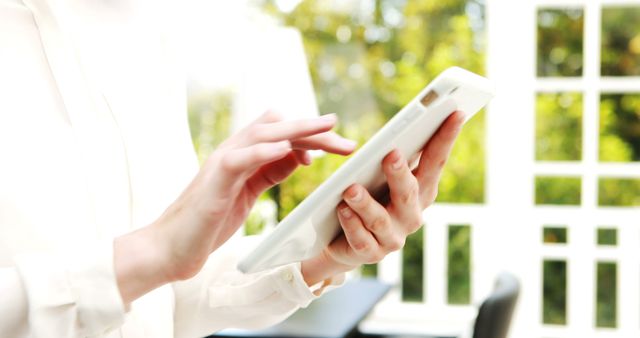 Person Using Tablet in Bright Home Office Environment - Download Free Stock Images Pikwizard.com