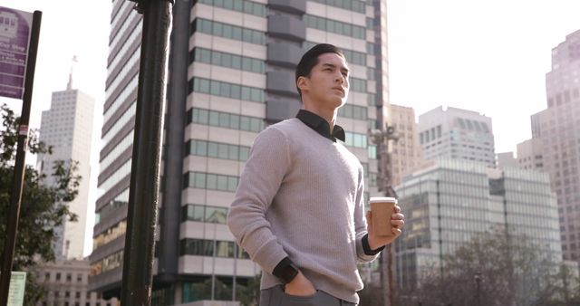 Confident Young Professional Holding Coffee in City Setting - Download Free Stock Images Pikwizard.com