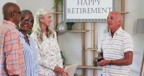 Senior friends celebrating retirement in warm ambience