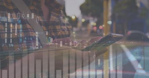 Man tapping smartphone on urban night street with animated market charts and data overlay
