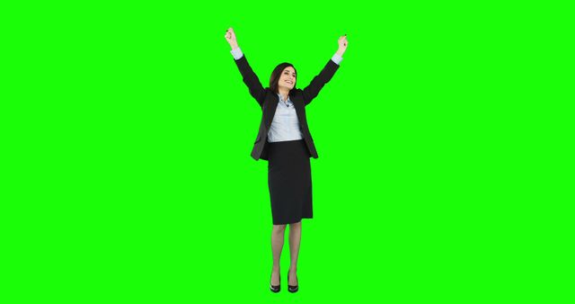 A jubilant businesswoman exults in her success against a green screen backdrop. - Download Free Stock Photos Pikwizard.com