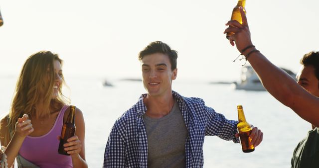 Young Friends Celebrating at Beach with Drinks in Summer Sun - Download Free Stock Images Pikwizard.com