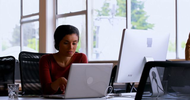 Focused Businesswoman Working in Modern Office with Digital Devices - Download Free Stock Images Pikwizard.com