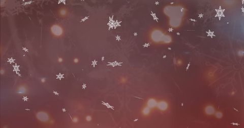 Festive snowflakes falling on glowing red background