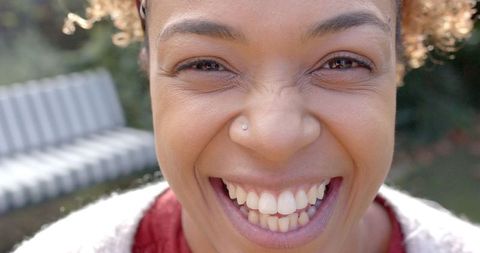 Close-up of Joyful African American Woman Smiling Outdoors