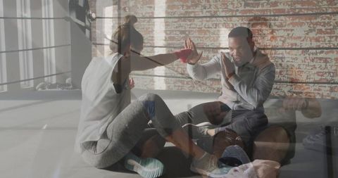 Trainee Practicing Boxing Jabs with Trainer in Loft Gym