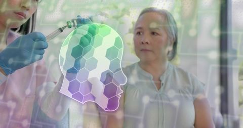 Mature asian woman receiving vaccine with nurse prepping syringe, neural hologram overlay