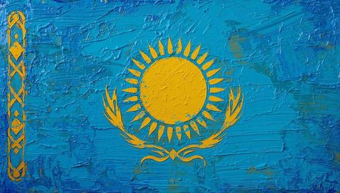 Textured kazakhstan flag with golden sun and steppe eagle emblem in thick impasto brushwork