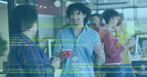 Curly man wearing lanyard gesturing and holding red mug during casual tech meetup with code overlay