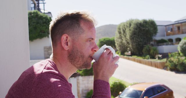 Man Drinking Coffee Outdoors Enjoying Scenic View from Balcony - Download Free Stock Images Pikwizard.com