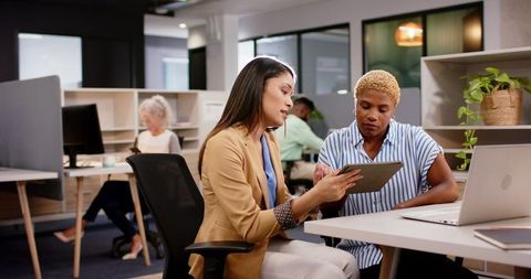 Businesswomen Using Tablet for Collaborative Project Discussion