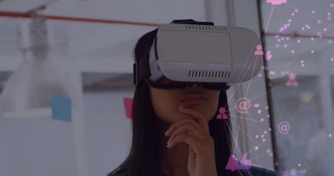 Asian Woman Exploring VR Technology in Modern Office Setting