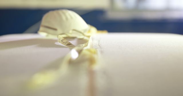 Close-up of Medical Mask on Clean Surface with Yellow Ribbons - Download Free Stock Images Pikwizard.com