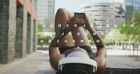 African American Woman Exercising with Smartphone and Headset in Urban Space