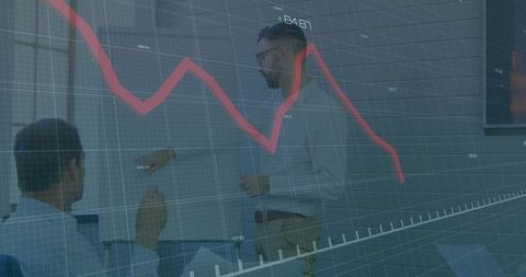 Business Professionals Analyzing Downward Financial Trend with Graph