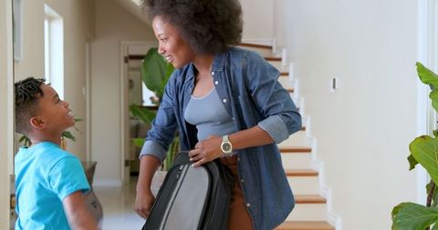 Smiling Mother Welcoming Son Home from School