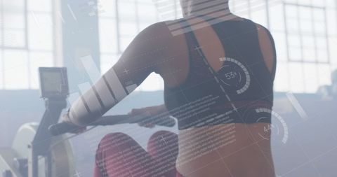 Woman exercising with digital data display in gym