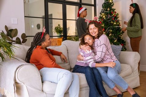 Diverse Family Celebrating Festive Joy Around Christmas Tree