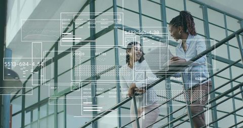 Diverse Professionals Collaborating on Staircase in Modern Office Atrium