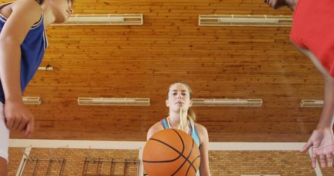 High School Teens Engaged in Exciting Basketball Match Indoors