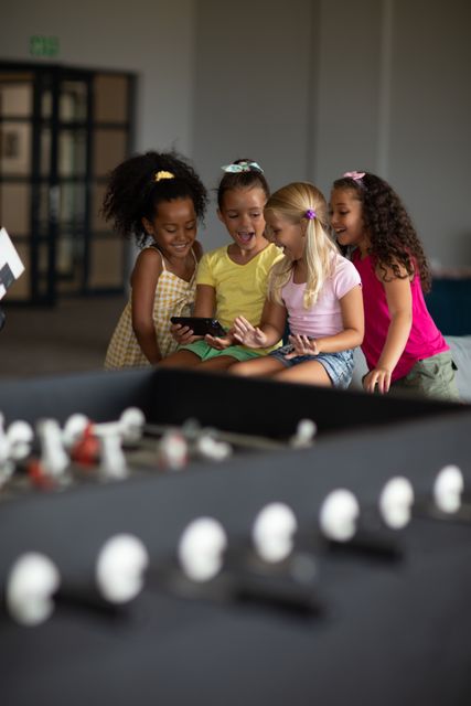 Cheerful Multiracial Schoolgirls Using Smartphone in Playroom - Download Free Stock Images Pikwizard.com