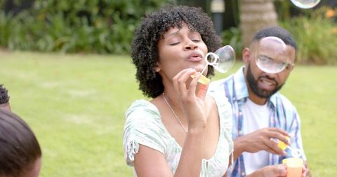 Joyful Family Blowing Bubbles Outdoors in Green Garden - Download Free Stock Images Pikwizard.com
