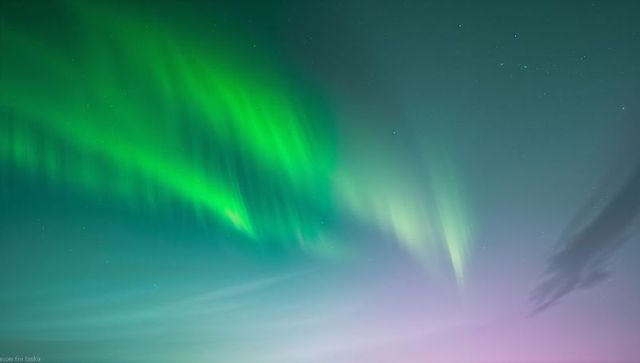 Dancing Green and Teal Aurora Curtains Sweeping Across Polar Night Sky
