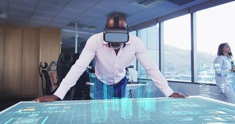 African american man interacting with virtual city using vr headset