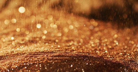 Abstract gold glitter sparkles in warm light
