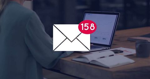 Envelope icon indicating unread alerts at busy office workspace