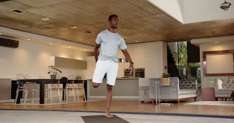Man Practicing Yoga Balance Pose in Modern Living Space