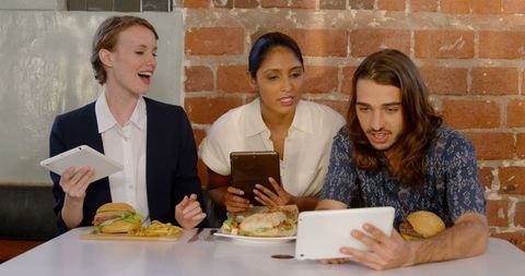Young Professionals Discussing Ideas Over Lunch With Digital Tablets - Download Free Stock Images Pikwizard.com