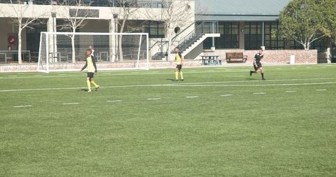 Teen Soccer Players Compete Aggressively on School Field