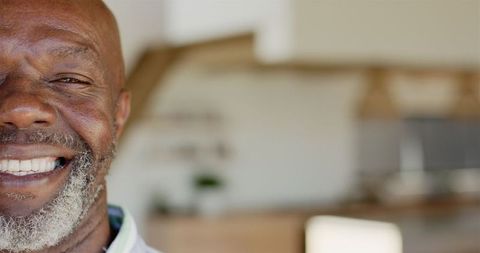 Joyful Mature Man with Infectious Smile Relaxing at Home