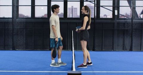 Padel Players Standing Opposite on Blue Urban Court