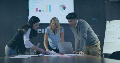 Collaborative Team Analyzing Sales Data in Modern Boardroom Environment